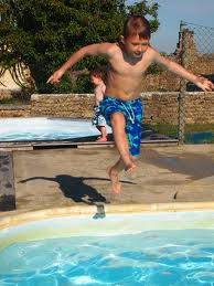 kid jumping into a pool